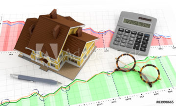 Model house and calculator on graph paper